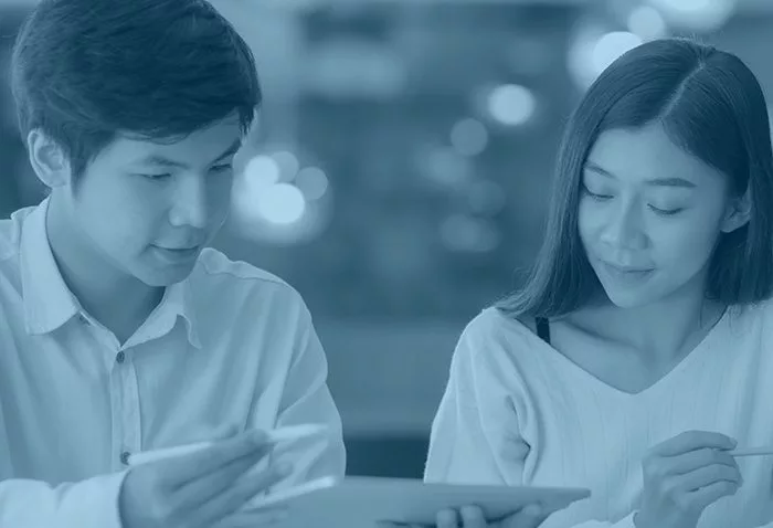 man and woman looking at tablet